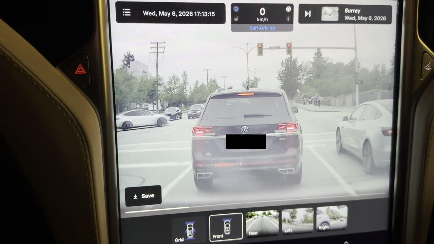 Model X center screen replaying dashcam footage, with Tesla&rsquo;s overlay showing the date, time, &ldquo;Self-Driving&rdquo; status, speed, and location &ldquo;Surrey&rdquo;